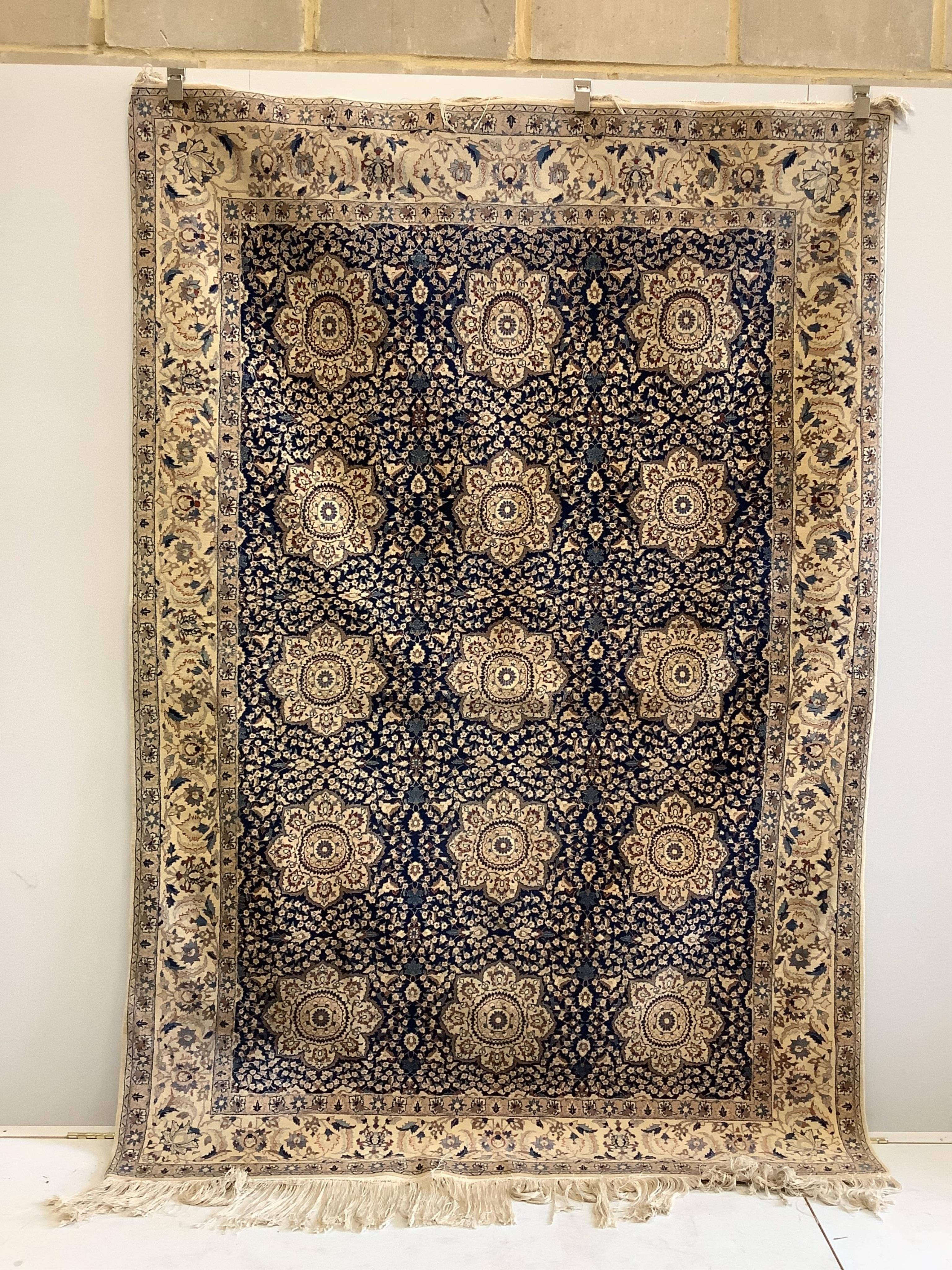 A North West Persian blue and ivory ground carpet with floral borders, 250 x 168cm. Condition - fair